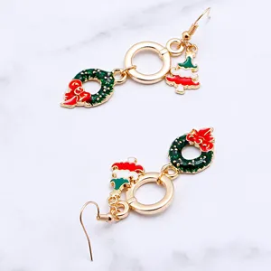 Christmas themed metal drop earrings featuring cute tree and wreath charms, holiday style jewelry.