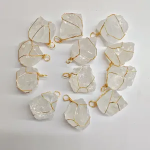 Raw white crystal quartz stone pendants wrapped in handmade gold wire for DIY jewelry making.