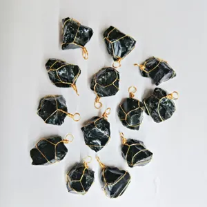 Close-up detail of irregular black crystal raw stone pendants with handmade gold wire wrapping.