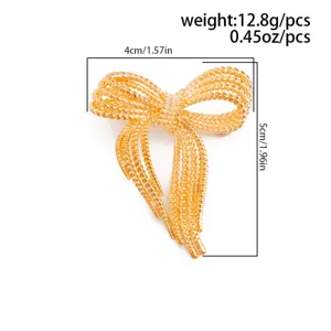 Detailed view of a gold bow brooch, featuring multi-layer woven mesh design with clear size.