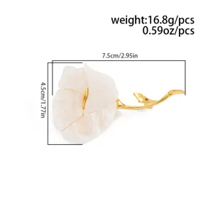 Close-up detail of the elegant white flower brooch featuring a polished gold stem pin.