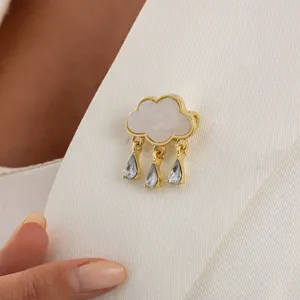Close-up detail shot of a creative cloud shaped brooch with glittering crystal waterdrop tassels.