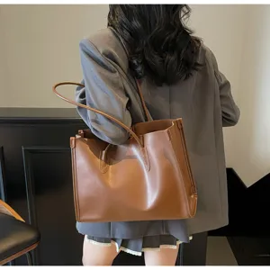Detail view of a stylish brown soft leather tote bag, large capacity shoulder underarm bag.