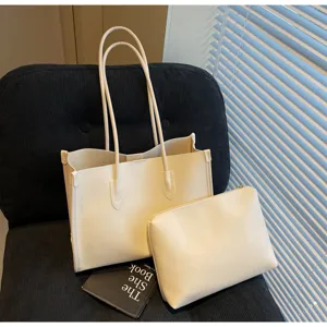 Detailed view of cream soft leather tote bag set with large capacity and matching pouch.