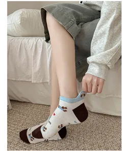 Detail view of women short socks featuring cute puppy embroidery and playful heel ear design.