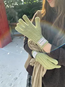 Guanti invernali in maglia treccia da donna, comodi guanti caldi verdi con etichetta sul polso.