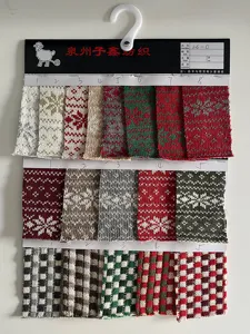 Christmas jacquard knit fabric swatch sample card with festive snowflake and plaid patterns.