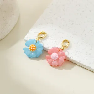 Mini daisy flower charm detail shot, cute macaron blue and pink DIY jewelry accessory.