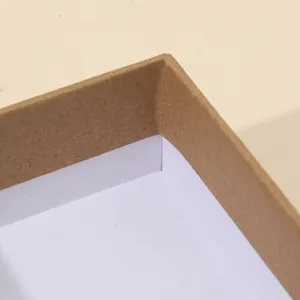 Detailed close-up of a premium kraft paper jewelry gift box corner with white inner lining for elegant packaging.