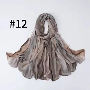 Detail view of the soft gradient silk-feel scarf, lightweight fabric texture close up.