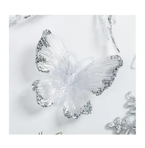 Clear acrylic butterfly Christmas tree decoration pendant with silver glitter details detail.