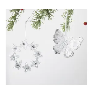 Detail shot of clear acrylic butterfly and flower wreath hanging ornaments with glitter accents.