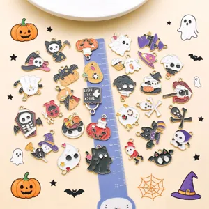 Close-up of assorted Halloween enamel charms, cute cartoon pumpkin and ghost DIY pieces.