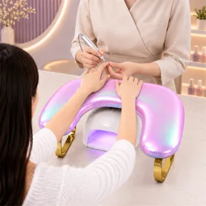 Ergonomic U-shaped nail hand pillow with gold stand, dual-hand PU leather manicure arm rest.