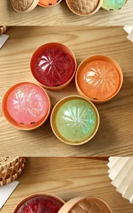 Colorful glitter baozi squishy toy with mini steamer basket for stress relief and fun.