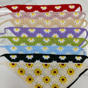 Detailed view of handmade crochet floral bandanas, featuring colorful knit daisies closeup.