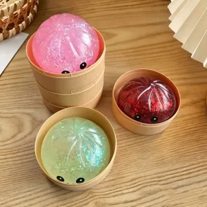 Cute colorful glitter baozi squishy toy set with mini steamer basket for stress relief.