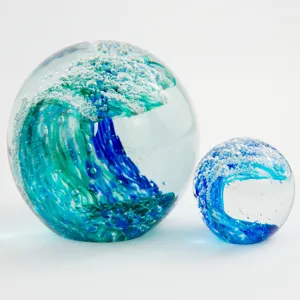 Handmade glass ocean wave ball paperweight and ornament set, clear crystal home decor piece.