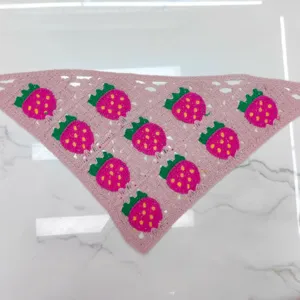 Detailed view of the cute pink crochet strawberry bandana, featuring vibrant knit flower motifs.