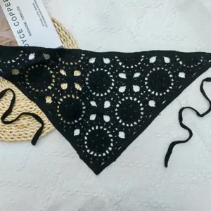 Detailed view of black crochet triangle scarf, hollow knit hair band fashion accessory.