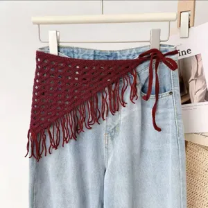 Detailed view of the dark red knitted crochet triangle scarf with fringe and tie straps.