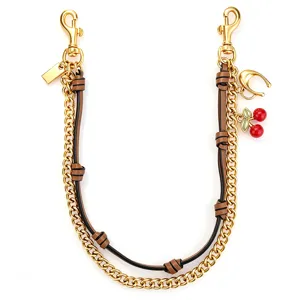 Chic metal and leather bag chain strap with cute cherry and horseshoe charms, gold hardware.