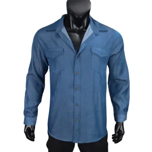 Blue denim long sleeve shirt detail showing classic lapel, chest pockets and front button closure.