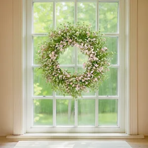 Artificial floral wreath with pink flowers and green leaves, perfect for wall and door decor.