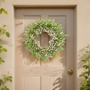 Artificial floral wreath with pink flowers and green leaves, perfect for door and wall decor.