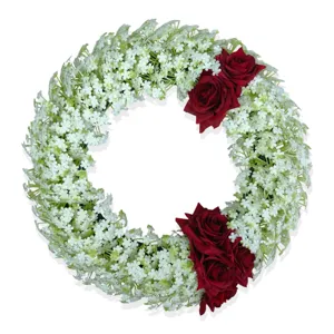 Exquisite detail view of artificial floral wreath with white baby's breath and red roses.