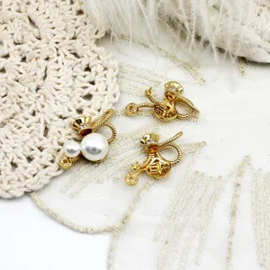 Close-up shot of gold lucky bag pendant DIY accessories with pearls and rhinestones.