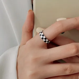 Chic black and white checkerboard ring, minimalist geometric design, stylish finger jewelry.