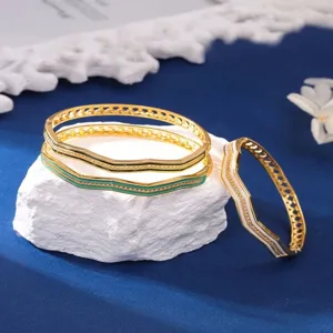 Detailed shot of exquisite geometric copper bangles with colorful enamel and sparkling zircons.