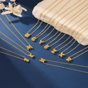 Golden alphabet letter pendant necklace set, delicate jewelry accessory for women.
