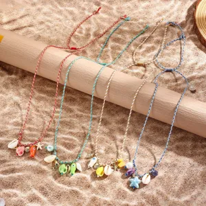 Detailed view of colorful braided rope necklace with ceramic ocean fish pendants, adjustable design.