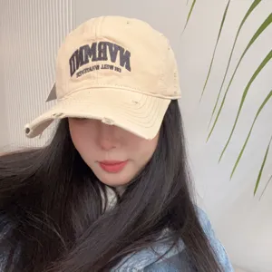 Beige distressed baseball cap for women, vintage dad hat with embroidery for casual wear.