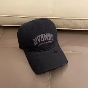 Distressed black baseball cap with embroidered lettering, casual vintage washed dad hat.