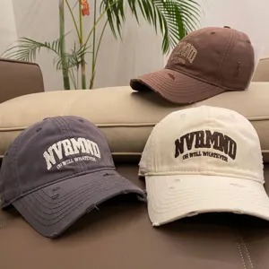 Distressed soft top baseball cap with embroidered lettering for casual spring and summer wear.