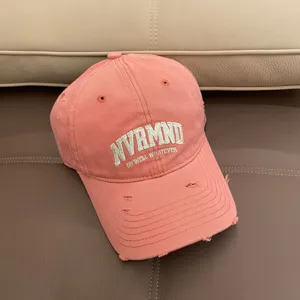 Pink distressed baseball cap for women with cool embroidered letters, casual fashion style.