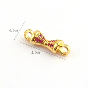 Gold-plated jewelry connector detail, DIY accessory featuring sparkling red stones.