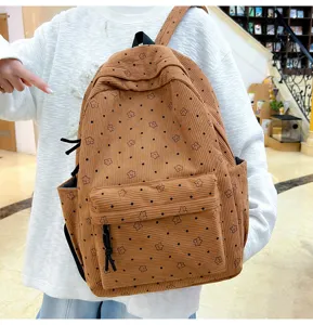 Sac à dos en velours côtelé marron avec motif d'étoiles, cartable élégant pour un usage quotidien.