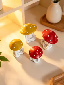 Detailed view of cute ceramic meditation mushroom figurines, modern home decor craft ornaments.