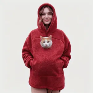 Cozy red fleece hoodie detail, soft plush fabric texture with front pocket and pet pouch.