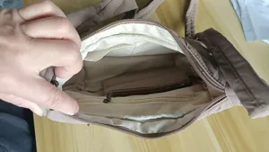 Nylon crossbody bag interior view showing multiple functional pockets and spacious storage design.