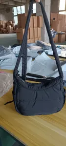 Black quilted shoulder bag detail showing soft dumpling bag texture and strap design.
