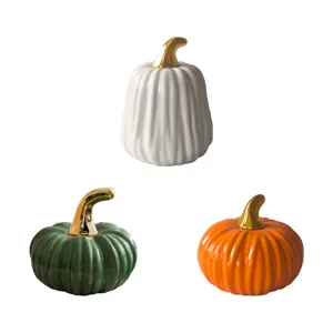 Ceramic pumpkin decor detail showing glossy finish and metallic gold stem in assorted colors.