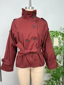 Detail view of the autumn women double-breasted belted short trench coat with stand collar.