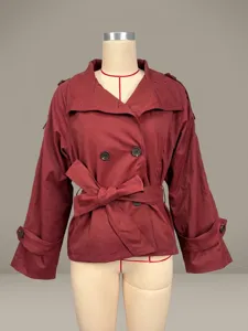 Detailed shot of the short trench coat showing double-breasted buttons and fabric texture.
