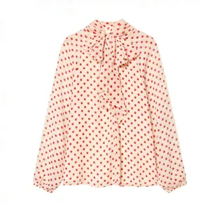 Detailed view of women's long sleeve polka dot blouse with elegant bow tie collar.