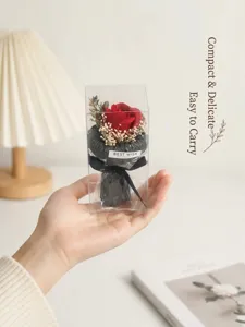 Mini pocket artificial rose flower bouquet in transparent gift box for party decor.